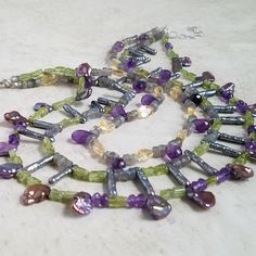 Statement Necklace at it's BEST!! Multi Strand Multi Gemstone Necklace, Luxury Natural Stone Necklace with Amethyst, Citrine, Peridot, Fresh Water Pearl - what an amazing combination!! Take a look at this gorgeous multi-gemstone, natural stone necklace, created with genuine green peridot, amethyst, faceted citrine, and biwa stick pearl. When you wear this 3 strands necklace, you give off a bold and confident vibe to everyone around you. This necklace is a perfect gift for yourself or those who were born in February (amethyst birthstone) or November (citrine birthstone). Amethyst and pearl are thought to offer both physical and mental health benefits to the wearer. The citrine gemstone is among the few gemstones that do not accumulate or hold any negative energy. Instead, it transforms nega Luxury Natural Stone Necklace For May Birthstone, Luxury Statement Multi-stone Gemstones, Luxury Amethyst Multi-stone Necklaces, Luxury Multi-stone Amethyst Necklaces, Luxury Multi-stone Necklace, Luxury Multi-stone Gemstones For May Birthstone, Luxury Multi-strand Pearl Necklace, Luxury Multi-stone Amethyst Gemstones, Cheap Multicolor Crystal Necklaces With Gemstone Beads