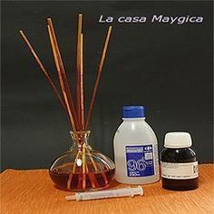 an assortment of essential oils and reeds on a table with the words la casa mayogica written in spanish