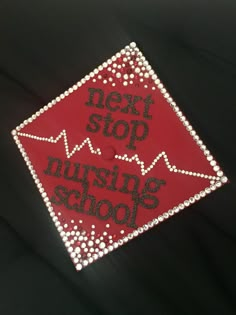 a red and white sign with the words next stop nursing school in black lettering on it