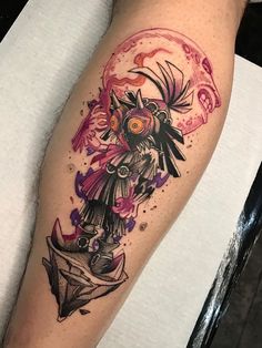 a tattoo on the leg of a person with an owl and bird in its head