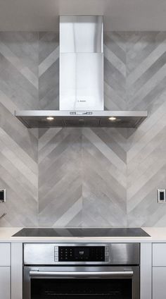 a stove top oven sitting inside of a kitchen next to a wall mounted range hood