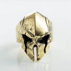 Reveal your warrior soul with this spartan helmet ring! discipline, determination, and surpassing yourself are the watchwords of the mighty spartan warrior. Hey you! Are you fans of The 300 movie or the antic roman army,if yes then this skull spartan ring is perfect for you, comes in 5 colors,black,bronze,silver,gold and pink for you ladies ;) so it can be worn with any outfit since so you see what suits your closet’s the best for the design it has great-looking carvings on the eyes to give off Helmet Ring, Mask Shapes, Spartan Helmet, Spartan Warrior, Shield Ring, Biker Jewelry, Viking Ring, Punk Vintage, Gothic Rings