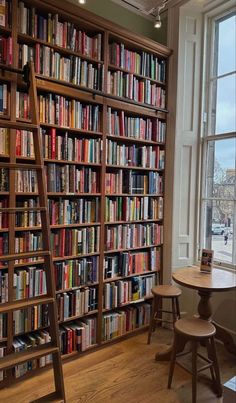 a ladder leaning against a bookshelf filled with lots of books