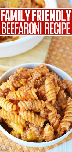 a bowl filled with pasta and meat on top of a table next to other dishes