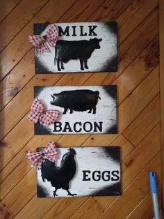 two black and white signs with farm animals on them that say milk, bacon, eggs