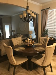 a dinning room table with chairs around it