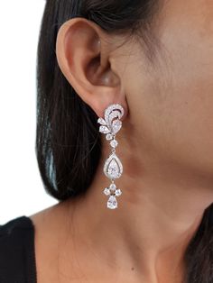 These filigree earrings are handcrafted in 925 Sterling Silver, they are embellished with white round-cut and pear-shaped CZ, bringing the total weight to 15 carats. Stunning piece and a great gift for women of all ages. About the Product: Metal: Solid 925 Sterling Silver Stones: Cubic Zirconia Grade: AAAAA Cut: Excellent Clarity: Excellent Why Buy from Adastra? 1. The USA patented 925 Sterling Silver, making each creation last for decades. 2. Each of our products is skin-friendly and eco-friend Luxury Crystal Bridal Earrings For Wedding, Diamond White Bridal Earrings With Brilliant Cut, Crystal Bridal Earrings Fine Jewelry For Wedding, Brilliant Cut Teardrop Bridal Earrings For Wedding, Diamond White Brilliant Cut Bridal Earrings, Elegant Wedding Chandelier Earrings With Diamond Cut, Brilliant Cut Teardrop Bridal Earrings, Crystal Bridal Earrings For Wedding, Teardrop Brilliant Cut Bridal Earrings