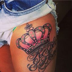 a woman's thigh with a crown tattoo on it