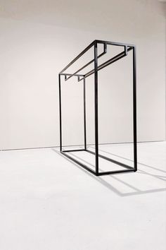 an empty room with a metal structure on the floor