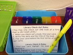 the library check - out rules are displayed in a plastic container with a yellow pen