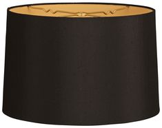 a black lamp shade with gold trim