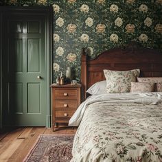 a bed sitting in a bedroom next to a wooden dresser and green door with flowers on it