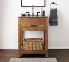 a bathroom with a sink, mirror and towel rack on the wall next to it