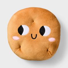 a round stuffed toy with eyes and nose