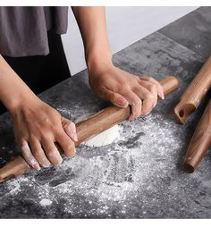 a person rolling dough on top of a table