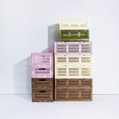 three baskets stacked on top of each other in front of a white wall and floor