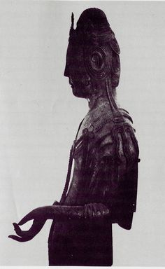 an old photo of a woman holding a snake in her hand and wearing a headdress