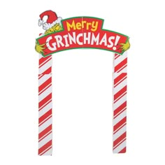 a merry grinmas arch with candy canes and santa hat on it's head