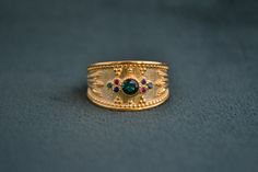 A byzantine ring with a variety of colorful stones on it. Entirely made with solid sterling silver (925 silver), with the addition of a 22k gold plating. In the center of the ring there is a round CZ Sapphire, and around it 6 round cz stones (Emerald, Ruby, Sapphire). Gold Bohemian Multi-stone Rings, Bohemian Gold Multi-stone Rings, Byzantine Style Emerald Ring For Gift, Byzantine Ring, Ring Stones, Byzantine Rings, Greek Ring, Colorful Stones, Pink Tourmaline Ring