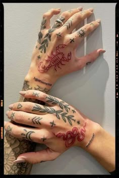 two hands with tattoos on them, one has an arrow and the other has stars