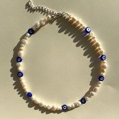 "Lovely little blue evil eye and a mix match of different size genuine cultured fresh water Pearls necklace❤️   This necklace is adjustable with a 2\" extension chain (worn at 16\" in photo)  Evil eye size: 8x8mm Pearl size: approximately 5-6x8-10mm and 9-13mm Clasp is stainless steel PACKAGING  This will come in a little organza gift bag so make the perfect present!  CARE OF ITEM Avoid contact with water/liquids as this may cause tarnishing to wire  Millefiori necklace Beaded necklace handmade necklace beaded choker handmade choker handmade jewellery beaded jewellery" Evil Eye Pearl Necklace, Trendy Adjustable Evil Eye Necklace, Trendy Handmade Adjustable Pearl Necklace, Trendy Adjustable Evil Eye Necklaces, Pearl Evil Eye Jewelry For Gifts, Pearl Evil Eye Jewelry As Gift, Evil Eye Pearl Jewelry As A Gift, Pearl Jewelry With Evil Eye Detail As Gift, Pearl Jewelry With Evil Eye As A Gift