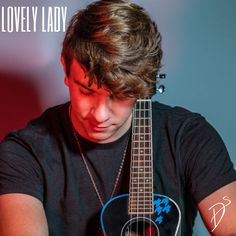 a young man holding a guitar in his right hand with the words lovely lady on it