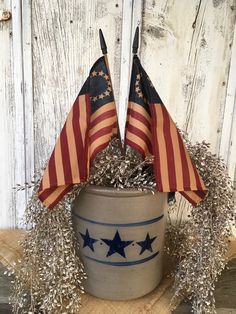 two american flags sticking out of a potted plant