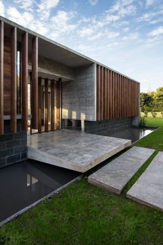 an outdoor area with steps leading up to a building that is made out of concrete and wood