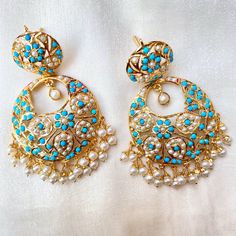 Pair of earrings in gold plated sterling silver. It has been embellished with precious freshwater pearls and turquoises. The earrings are light and comfortable to wear at just 28gms per pair. Silver Earrings Set, Hyderabadi Jewelry, Bridal Jewelry Sets Brides, Bridal Jewelry Vintage, Gold Jewelry Simple Necklace, Peridot Jewelry, Chandbali Earrings, Indian Jewellery Design Earrings, Antique Jewelry Indian