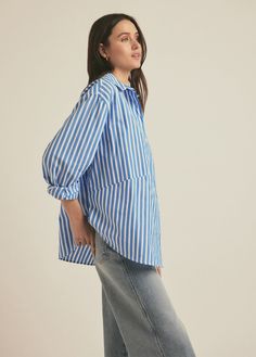 We took our best-selling Ex-Boyfriend Shirt and opened it up (just a bit). The Door's Always Open Ex-Boyfriend Shirt is an oversized button up with a relaxed fit, pointed collar and open hem. It is cut in a soft cotton poplin in Azure Stripe.100% Cotton Yarn Dye Gaby is 5'9" wearing size S. Blue Vertical Striped Collared Top, Blue Tops With Striped Collar And Relaxed Fit, Boyfriend Shirt, Ex Boyfriend, Yarn Dyeing, Cotton Poplin, Cotton Yarn, Button Up, Dye