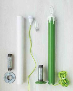 some green and white items are on the table with wires, plugs, and earphones