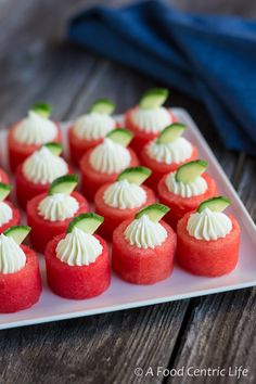 some watermelon bites topped with feta and cucumber on a plate