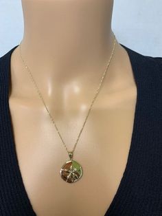 "14k solid gold Sand Dollar pendant. measures 1\" by 3/4\". High polish finish on 18\" solid gold chain. ** includes 14k solid gold 18\" chain **" 14k Yellow Gold Cross Pendant Charm Necklace, Gold 14k Cross Pendant Charm Necklace, Round 14k Gold-tone Charm Necklaces, Round Gold-tone 14k Gold Charm Necklace, 14k Gold Cross Pendant Charm Necklace, Round 14k Gold-tone Charm Necklace, Gold Flower Pendant Charm Necklace In 14k, Gold Charm Necklace With Large Round Pendant, Gold Necklace With Large Pendant In 14k Gold