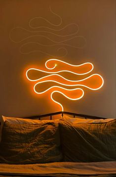 a room with a bed and a neon sign on the wall