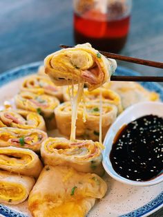 a plate filled with food and dipping sauce