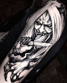 a man with a tattoo on his arm holding a knife