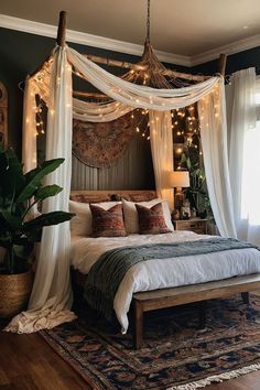 a bed with white curtains and lights hanging from it's headboard in a bedroom