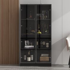 a glass cabinet with bottles and glasses on it next to a chair in a room