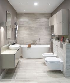 a bathroom with two sinks, a tub and a toilet is shown in this image