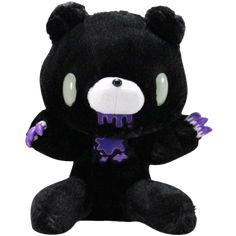 a black teddy bear with purple teeth and fangs