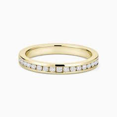 a yellow gold wedding band with channel set diamonds