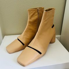 Never Worn Comes With Original Box, Dust Bag Beige Ankle Boots For Office, Modern Beige Calf Leather Boots, Beige Square Toe Heeled Boots For Work, Modern Beige Leather Heeled Boots, Chic Square Toe Heeled Boots With Leather Lining, Designer Square Toe Heeled Boots Medium Width, Beige Square Toe Boots With Leather Sole, Beige Leather Boots With Square Toe, Designer Heeled Boots With Square Toe And Medium Width