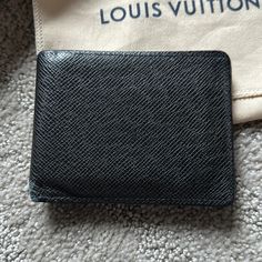 Louis Vuitton's Multiple Wallet Holds Credit Cards, Bills And Receipts In An Extremely Compact Format. It Is Part Of The Taga Leather Range, Louis Vuitton's Very First Collection For Men. Product Details 4.7 X 3.5 X 0.6 Inches (Length X Height X Width) 3 Card Slots 2 Inside Pockets 2 Compartments For Bills And Tickets 2 Side Slots For Receipts Taiga Cowhide Leather Cowhide Leather Lining This Authentic Wallet Comes With The Box And Dust Bag. It’s Worn Out On The Top And Bottom Edges When It Folds. The Lv On The Bottom Right Corner Is Worn Out And Is Very Faint. The Heat Engraved Label Is Still On The Wallet. The Inside Also Shows Some Wear But It’s Not Bad. The Last Photo Was Take Louis Vuitton Mens Wallet, Louis Vuitton Men, Wallet Men, Inside Pocket, Cowhide Leather, Louis Vuitton Bag, Louis Vuitton, Man Shop, Wallet