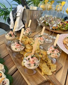 some food is sitting on a table with wine glasses and other dishes in front of it