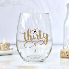 a wine glass with the word thirty written on it