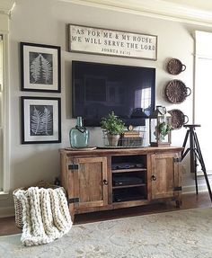 a living room with an entertainment center and pictures on the wall above it that says best farmhouse living room remodel ideas