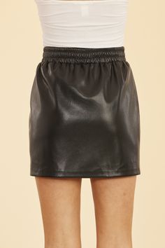 A classic example of the perfect fall skirt, our Faux Leather Mini Skirt with Elastic Waistband adds an edgy touch to any outfit. Crafted from premium faux leather, this mini skirt features a comfortable elastic waistband for a flattering fit that moves with you. Pair it with a blouse and heels or dress it down with a cozy sweater, tights, and ankle boots. Faux leather Mini length Elastic waistband Available in Coffee and Black Dry clean Style: 75509 Sleek Faux Leather Mini Skirt For Fall, Casual Faux Leather Mini Skirt With Lining, Black Leather Mini Skirt For Fall, Fall Leather Mini Skirt For Going Out, Fall Faux Leather Mini Skort, Fall Faux Leather Pencil Mini Skirt, Trendy Faux Leather Mini Skirt For Date Night, Trendy Faux Leather Skort For Fall, Faux Leather Mini Skirt For Date Night