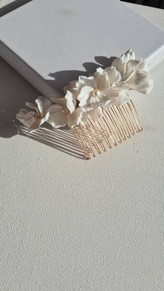 Rae's bridal hair comb will perfect any bride's romantic glamorous waves or soft effortless hair up. Made with handmade flowers in different sizes clay flowers, adorned with tiny freshwater pearls and seed beads, hand-wired onto a silver or gold hair comb.  Perfect for your garden-inspired wedding. Sent beautifully packaged in a Medze Bride gift box. As Rae's hair comb is made to order especially for you, I cannot accept refunds/exchanges. But if you have any problems with your order please emai Bridal Hair Comb Flowers, Bridal Floral Hair Comb, Floral Hair Comb Wedding, Wedding Hair Combs, Flowers Wedding Hair, Pearl Bridal Hair Comb, Effortless Hair, Floral Bridal Comb, Pearls Hair