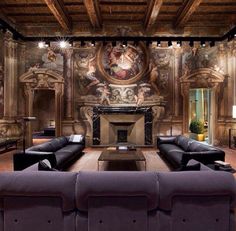 an ornate living room with black leather couches