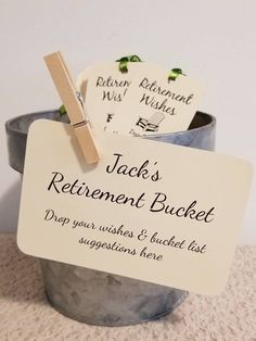 there is a sign that says jack's retirement bucket on the side of a potted plant